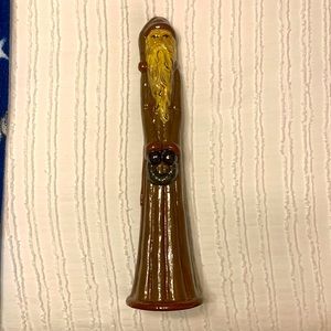 Tall, slim Redware pottery Santa Clause holding wreath.